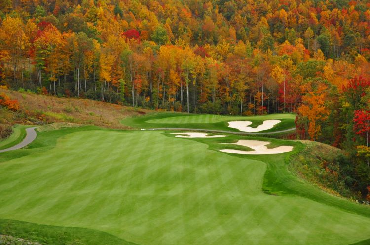 Golf Course With Yellow And Red Trees Along The Edge